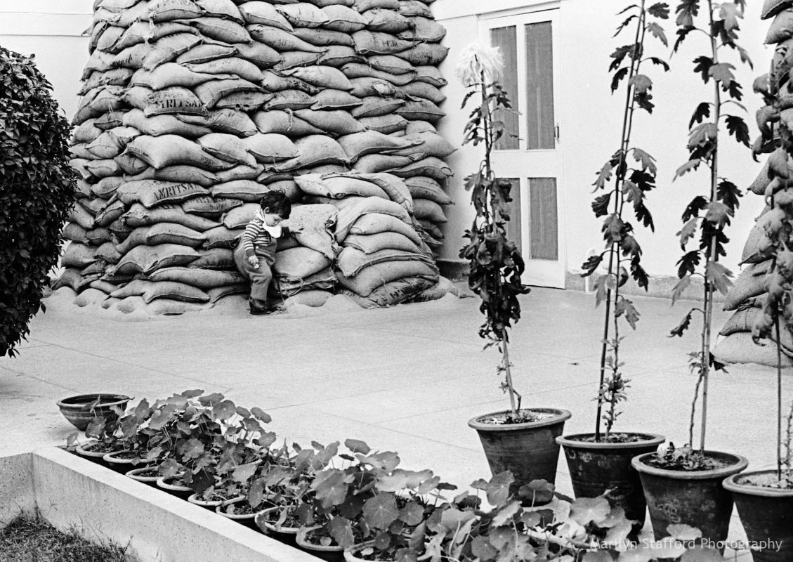 Rahul, grandson of Indira Gandhi, playing beside sandbags, which were used to protect his grandmother’s house during the Indo-Pakistani War, New Delhi,1972.